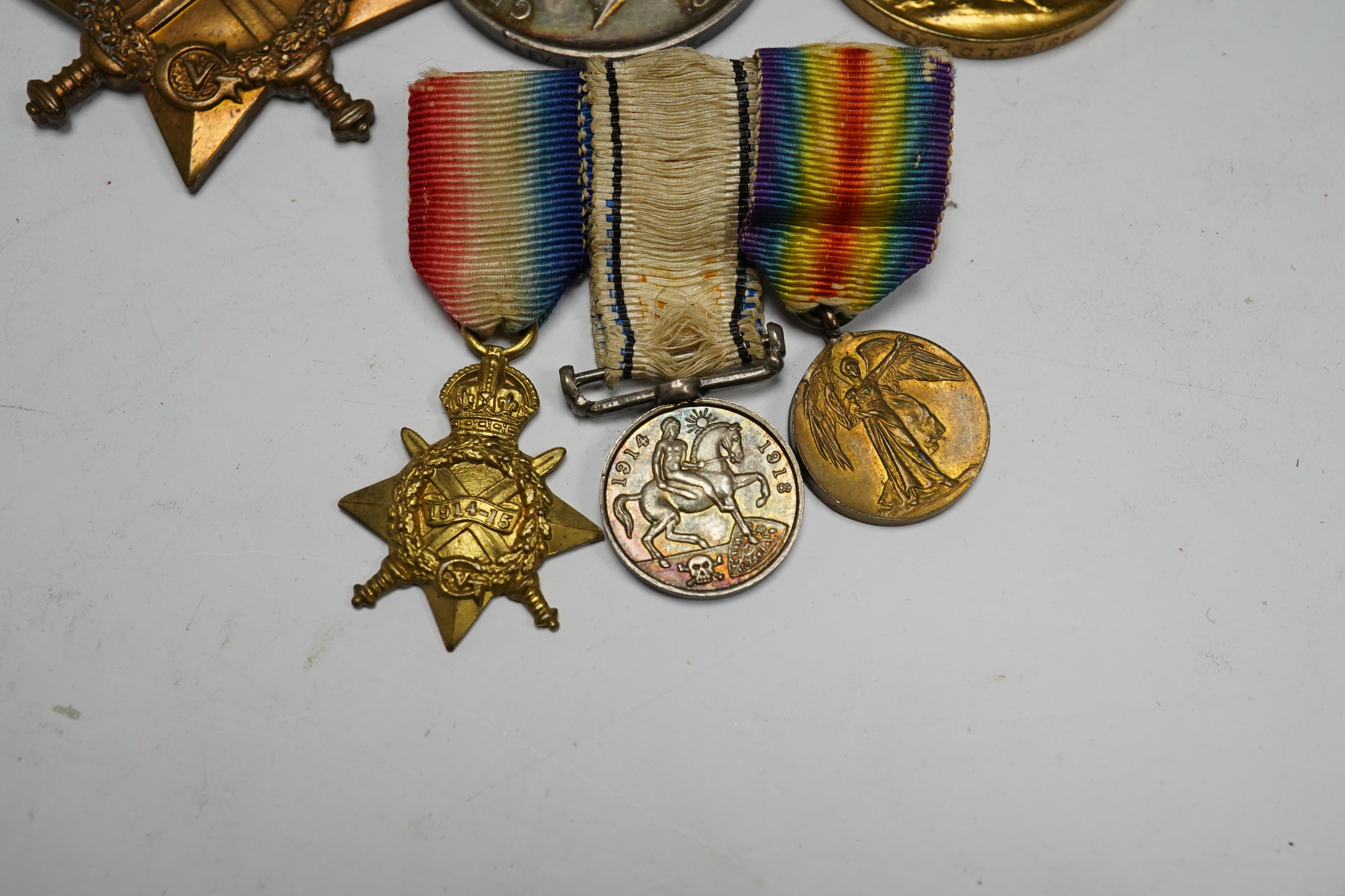 A First World War medal trio awarded to the Rev. P.C.T. Crick A.C.D., together with the miniature set. Condition - poor to fair.